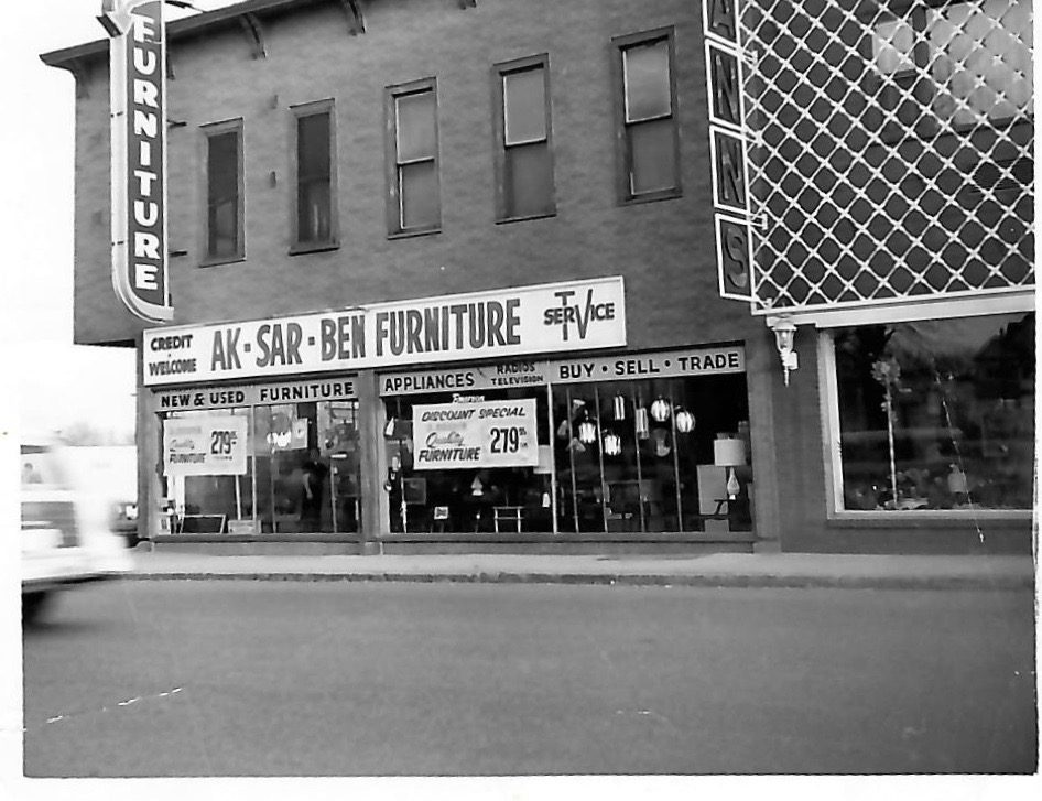 Black and white building photo of Aksarben Furniture and Television Repair, shown in 1962