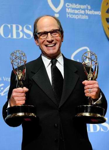 Harry Friedman holds two of the 14 Emmys he received during a decades-long career producing “Jeopardy” and “Wheel of Fortune.”