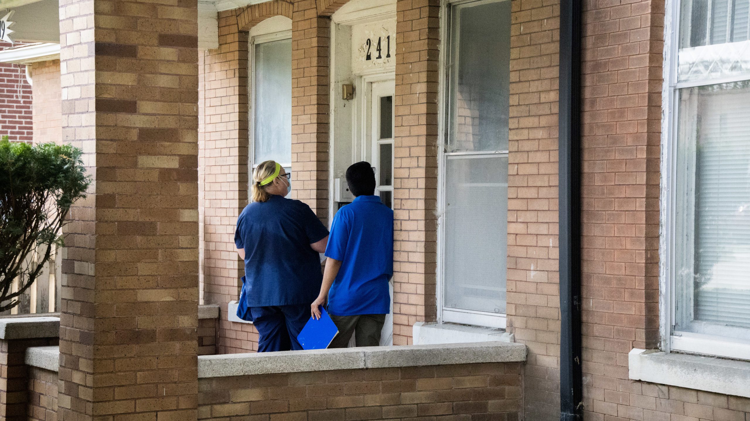 Mary McConnaughey and Eddie Nunez, One World vaccine outreach employees, knock on a door while walking through a South Omaha neighborhood to offer residents the COVID-19 vaccine. 