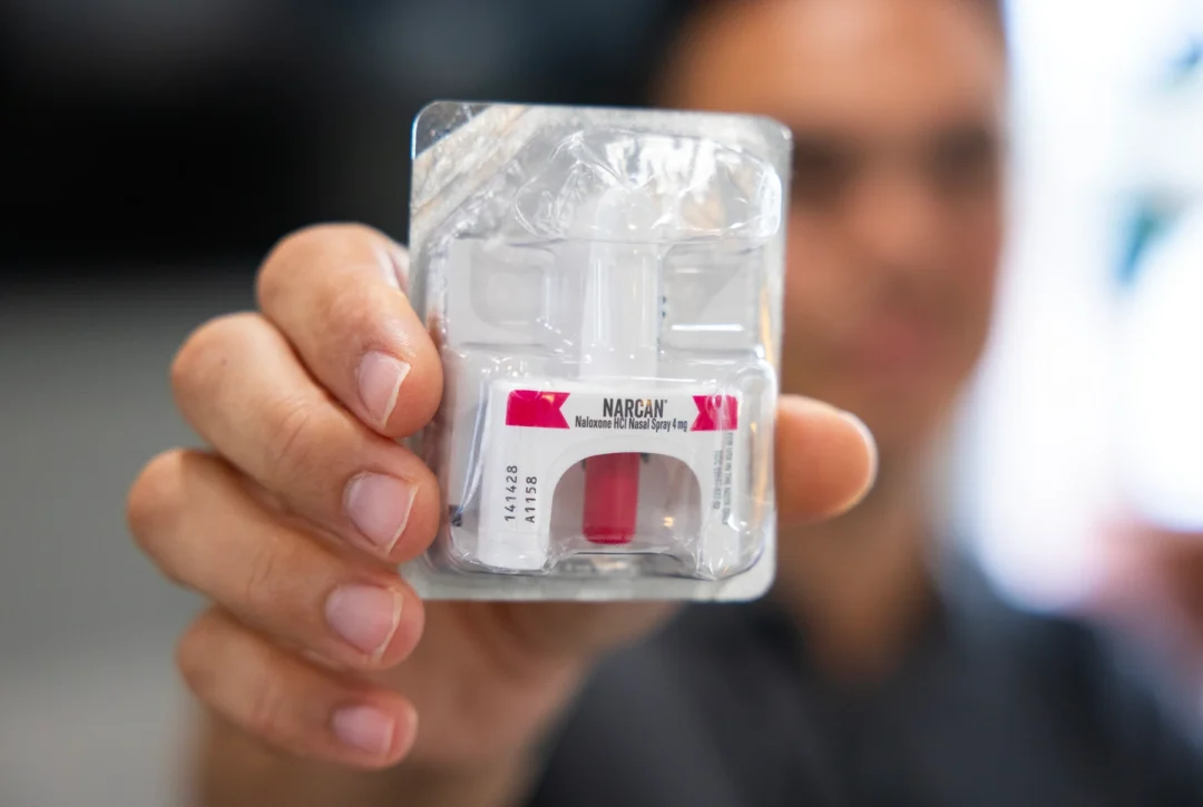 Paul Weishapl, a harm reduction instructor in UNMC’s College of Public Health, holds a dose of Narcan.